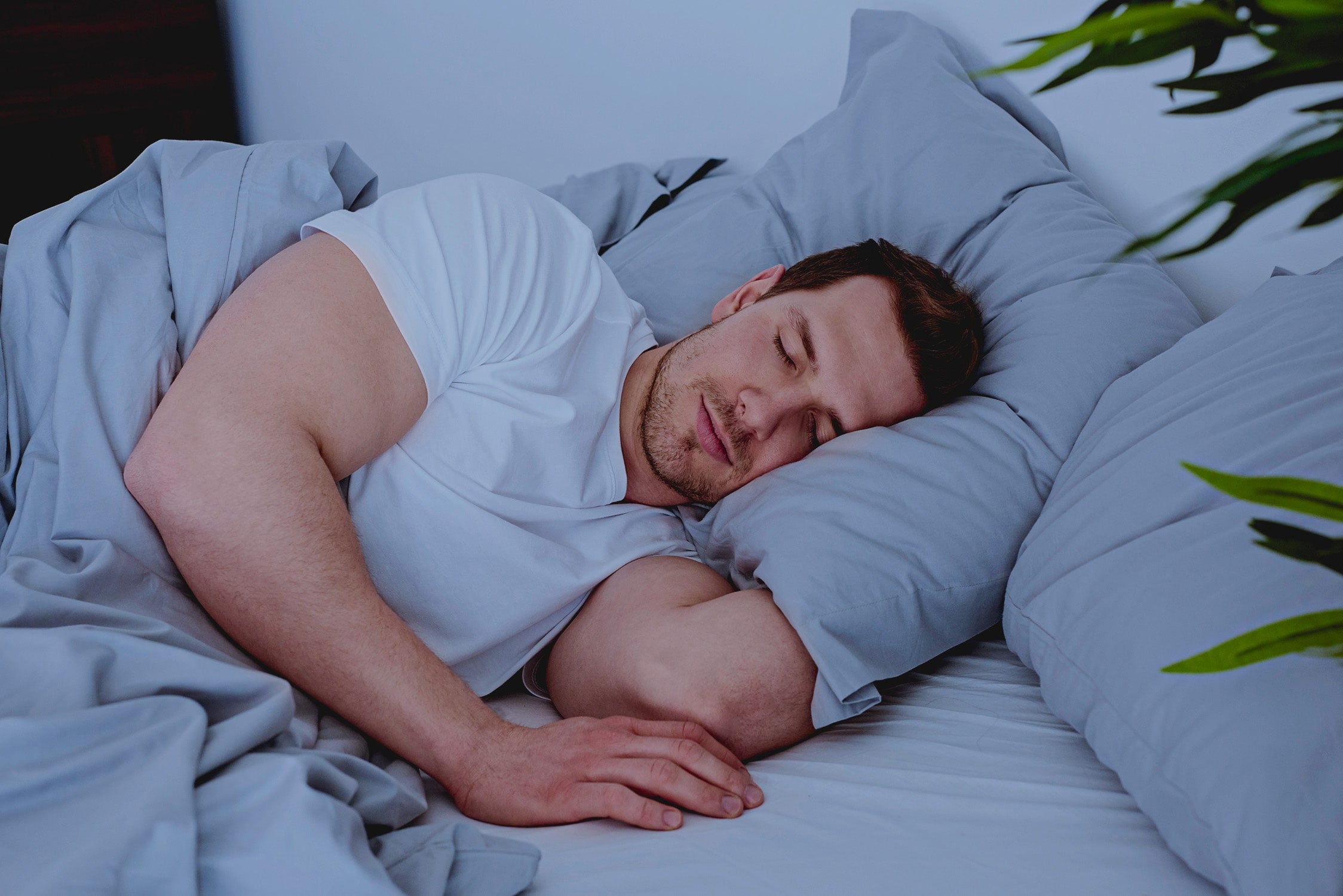 man-sleeping-comfortable-bed-min.jpg